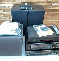 Front view of all units: Yamaha CD player, Onkyo amp, Onkyo CD player, two Cambridge subwoofers, remote and manuals
