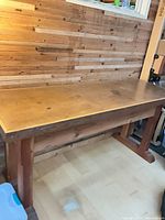 Full view of the wooden work table against wall