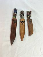 Knives inside leather sheaths