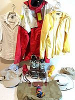 Overall view showing all garments, boots, hats, umbrellas and bag