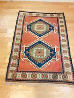 Full view of rug showing overall design, colors and fringe