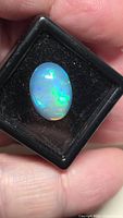 Front view of 5.20ct oval Ethiopian opal in display case