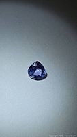 Front view of pear-cut tanzanite showing color and facets