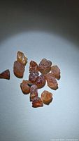 Group of rough spessartite garnet crystals on white background
