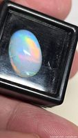 Front view of opal in box highlighting play-of-color
