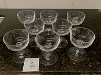Eight Dansk Ursula crystal coupe glasses grouped on countertop