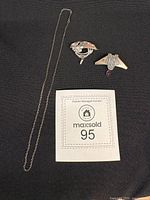 Overall view of chain and two brooches