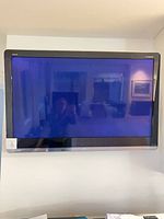 Front view of wall-mounted Sharp Aquos 46-inch TV