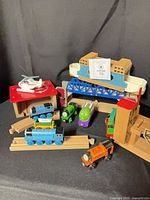 overview of engines, track pieces, bridge and helicopter set out for display