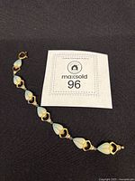 Full view of bracelet next to lot tag