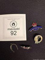 Overview of all four vintage pins and charm with lot card