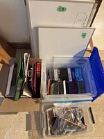 Overall lot showing whiteboards, binders, plastic totes with pens and discs
