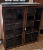 Front view of cabinet showing dual glass-pane doors and top