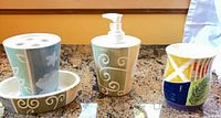 Full view of three matching ceramic pieces and separate tumbler