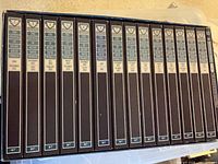 Sixteen uniform spined hardcover volumes in a row