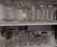Two shelf view of all jars and funnel