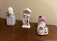 Three ceramic nursery-rhyme figurines grouped on table