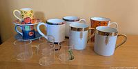 Entire assortment showing all mugs, cup-saucer sets and glass cups