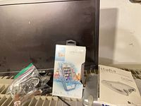 ASUS monitor, LifeProof case, Formac Studio guide and device visible together