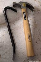 Hammer and wrecking bar on surface