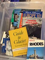 Bin filled with assorted guidebooks and maps