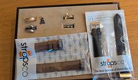 Overview of all jewelry pieces on display pad and two packaged StrapsCo watch bands