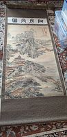 Full view of Chinese scroll painting with silk borders and wooden rod