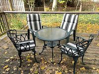 Full patio set: table, two cast metal chairs, two sling chairs with cushions