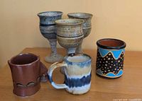 Group of three pottery goblets and three mugs