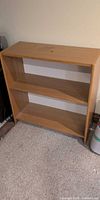 Full front view of open maple laminate shelf unit