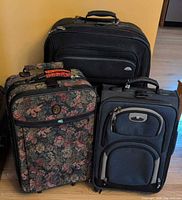 Group shot of all three suitcases standing upright