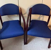 Front view of both blue upholstered wooden armchairs