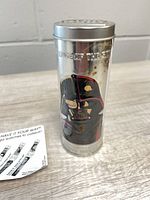 Cylindrical tin showing Darth Vader graphic side
