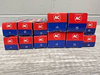 Front view showing all eleven AC Rapidfire spark plug boxes with numeric labels