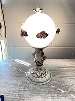 Full view of illuminated Capodimonte porcelain globe lamp