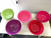 All eleven plastic serving bowls grouped on tabletop