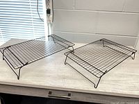 Both wire cooling racks on table showing size and shape