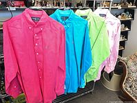 All four Ralph Lauren shirts hung side by side showing colors and style