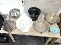 All eight strainers displayed on table