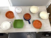 All eight bowls and crocks arranged on table