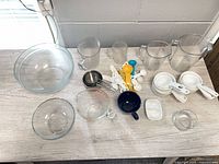 overview of all measuring cups, bowls, spoons on tabletop