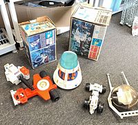 Group shot showing two Major Matt Mason boxes and assorted plastic vehicle parts