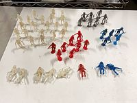 Overview of all 50 plastic space figures arranged by color
