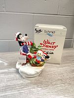 Front view of music box figurine with original box