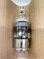 Full view of Valvo PL5544 vacuum tube showing glass upper section, metal lower section and 4-pin base