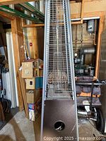 Full frontal view of pyramid patio heater showing grid and base