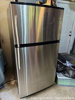 Full view of GE stainless steel top-freezer refrigerator