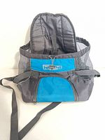 Front view showing Outward Hound logo, blue panel, mesh sides, drawstring top, front pocket