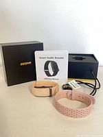 Full lot: smart bracelet in beige band, pink strap, charger, manual, boxes