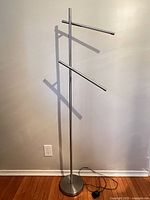 Full view of silver metal floor lamp with three horizontal LED arms
